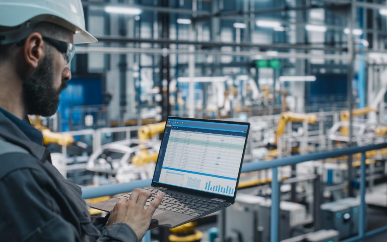 Engineer working with advanced manufacturing control systems